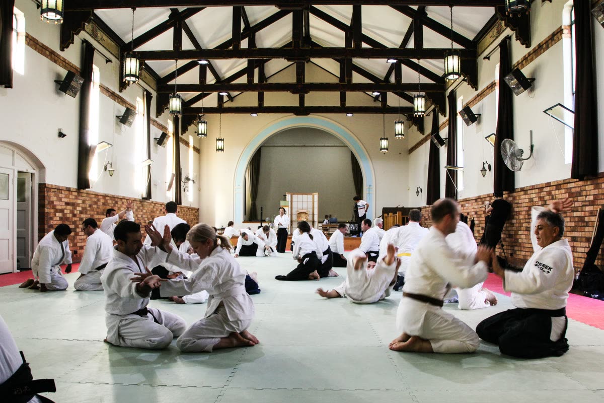 Students seated in pairs in the hall at the Ku-ring-gai dojo
