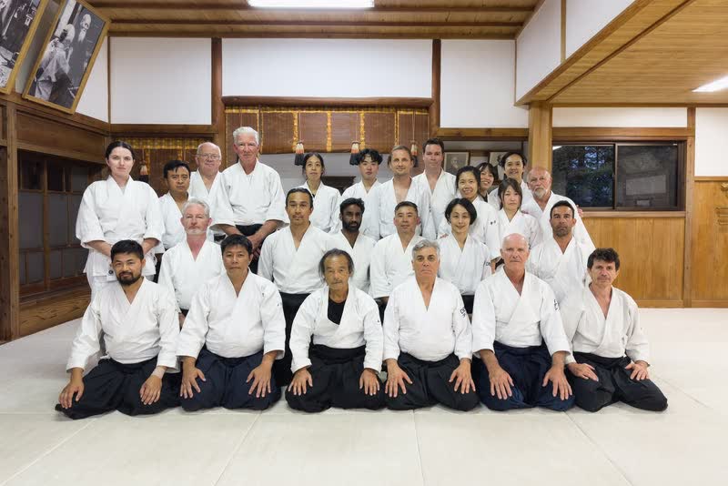 A group photograph inside the dojo at Iwama