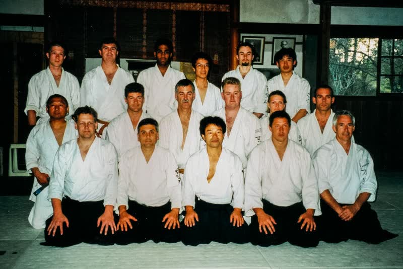 Group photograph inside the Iwama dojo, Takayasu Sensei seated at the centre