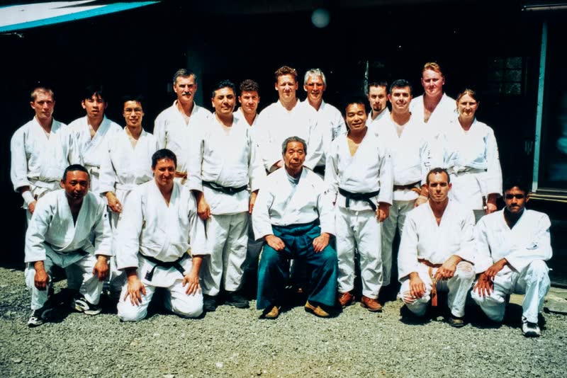 Group photograph outside the Iwama dojo, Saito Sensei seated at the centre