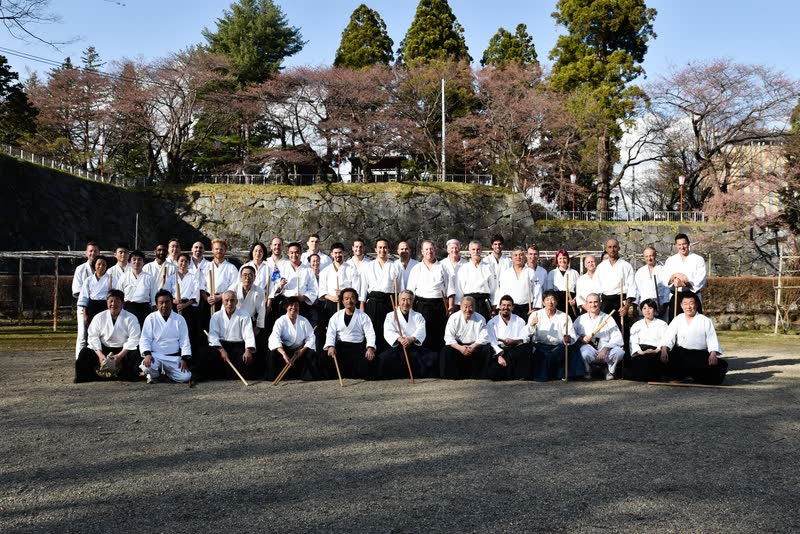 Group photograph after training beneath the cherry blossom in the grounds of Morioka castle, jo in hand