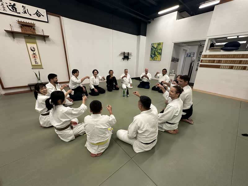 Sake shared in a circle on the mat after the first training of the new year