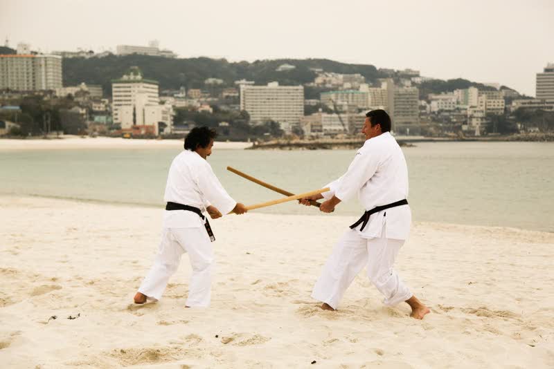 Takayasu Sensei and Peter Bolt working kumitachi on the beach at Tanabe