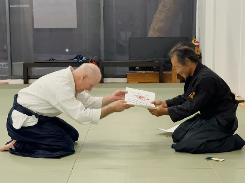 Ian Thomson Sensei receiving his 6th Dan certificate from Takayasu Sensei