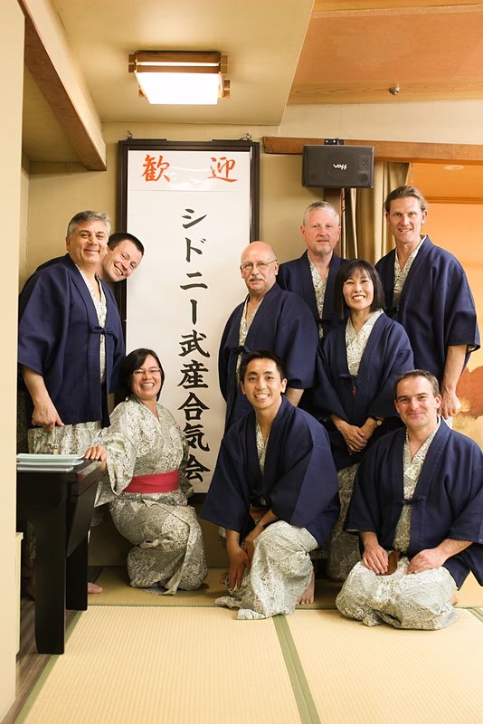 Group photo in front of sign "Sydney Takemusu Aiki Association"